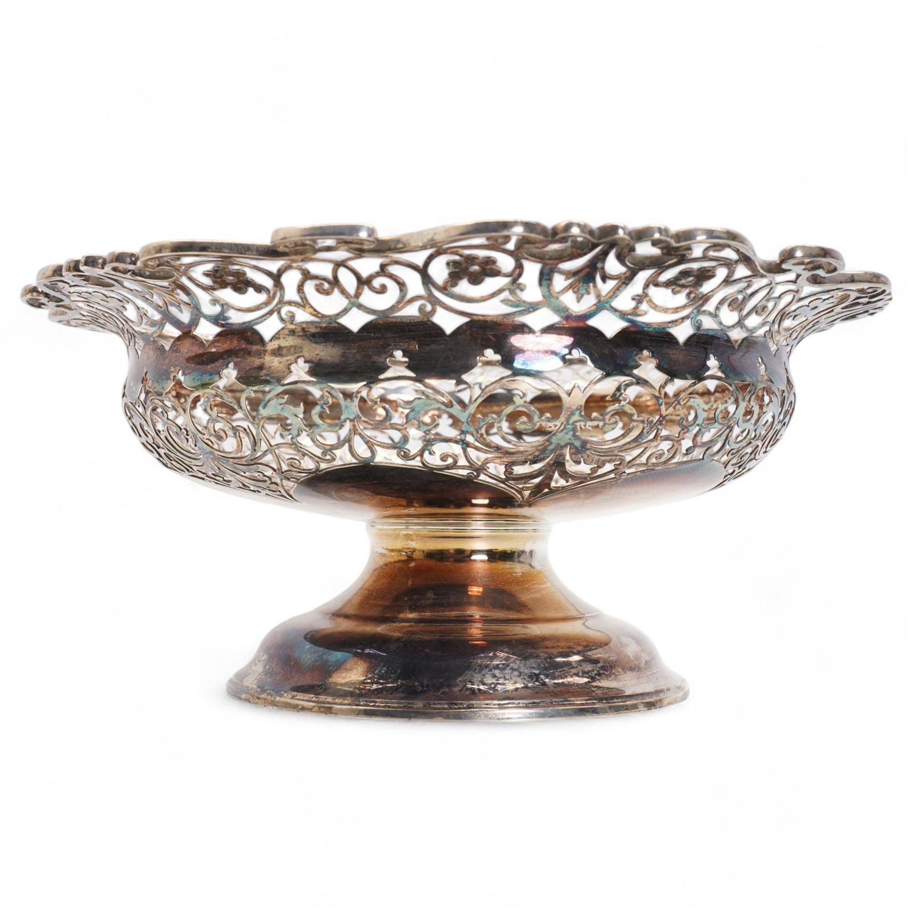 Edwardian silver circular fruit basket with flower head and scroll pierced border on a short pedestal foot D25cm London 1908 Maker Josiah Williams & Co