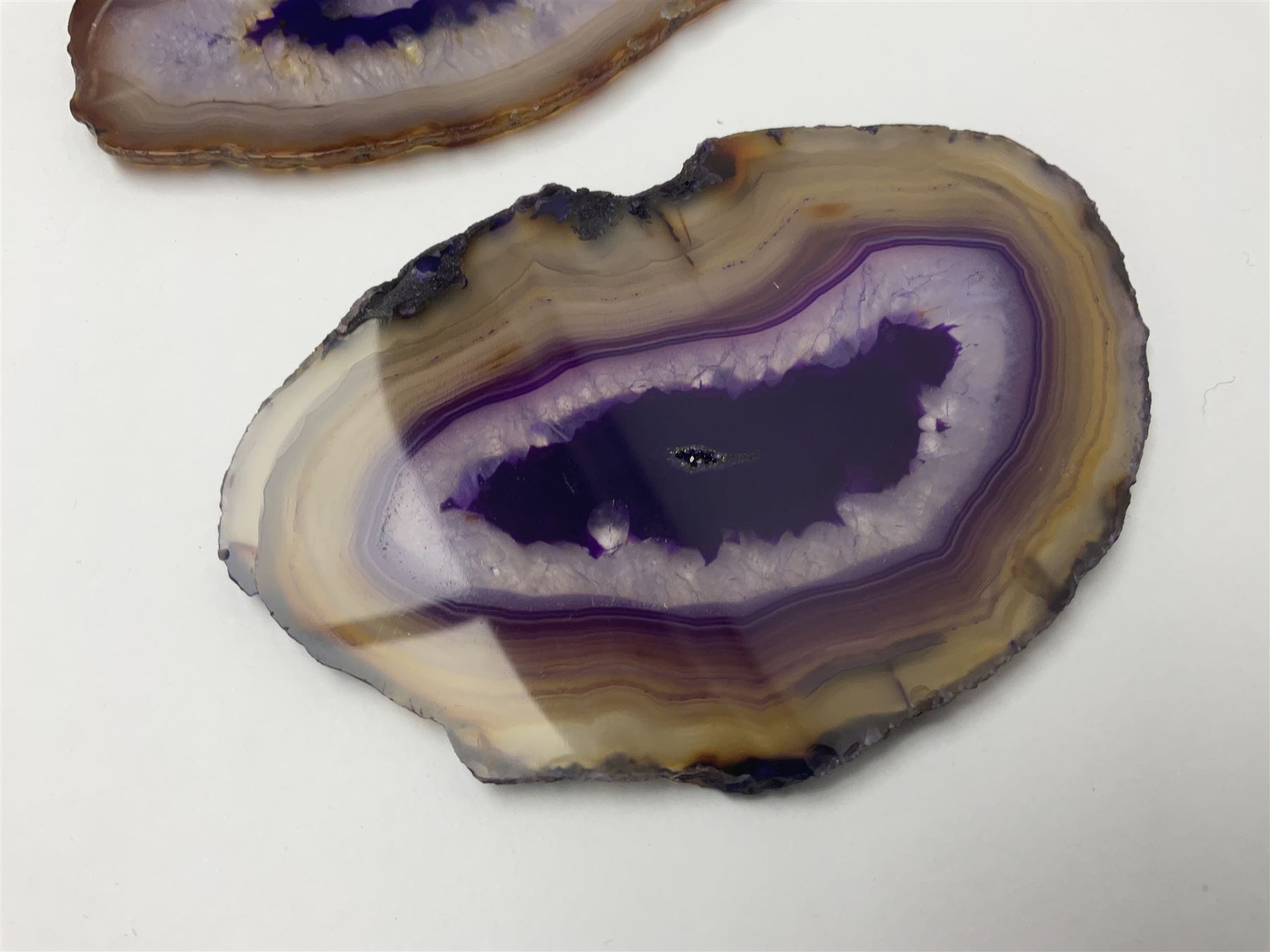 Three purple agate slices, polished with rough edges, of various sizes largest H7cm, L10cm