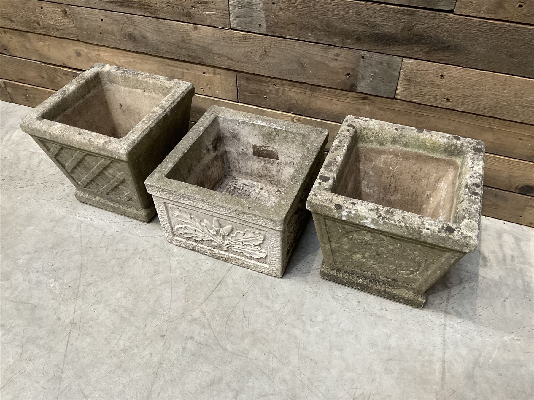 Pair of square cast stone planters, single planter with leaf decoration and a rectangular brick effect planter (4)