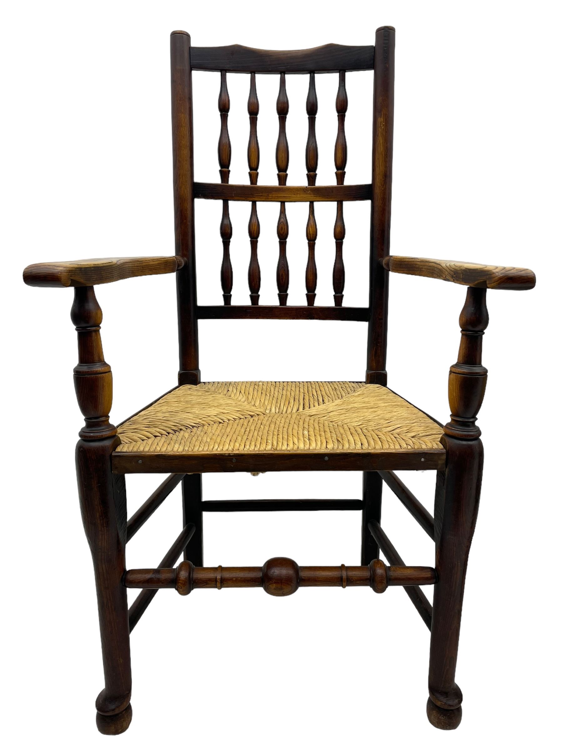 Matched set of twelve 19th century elm Lancashire spindleback dining chairs, shaped cresting rail over spindle back, rush seat, on turned supports united by turned stretchers, ring and globular turned front stretcher 