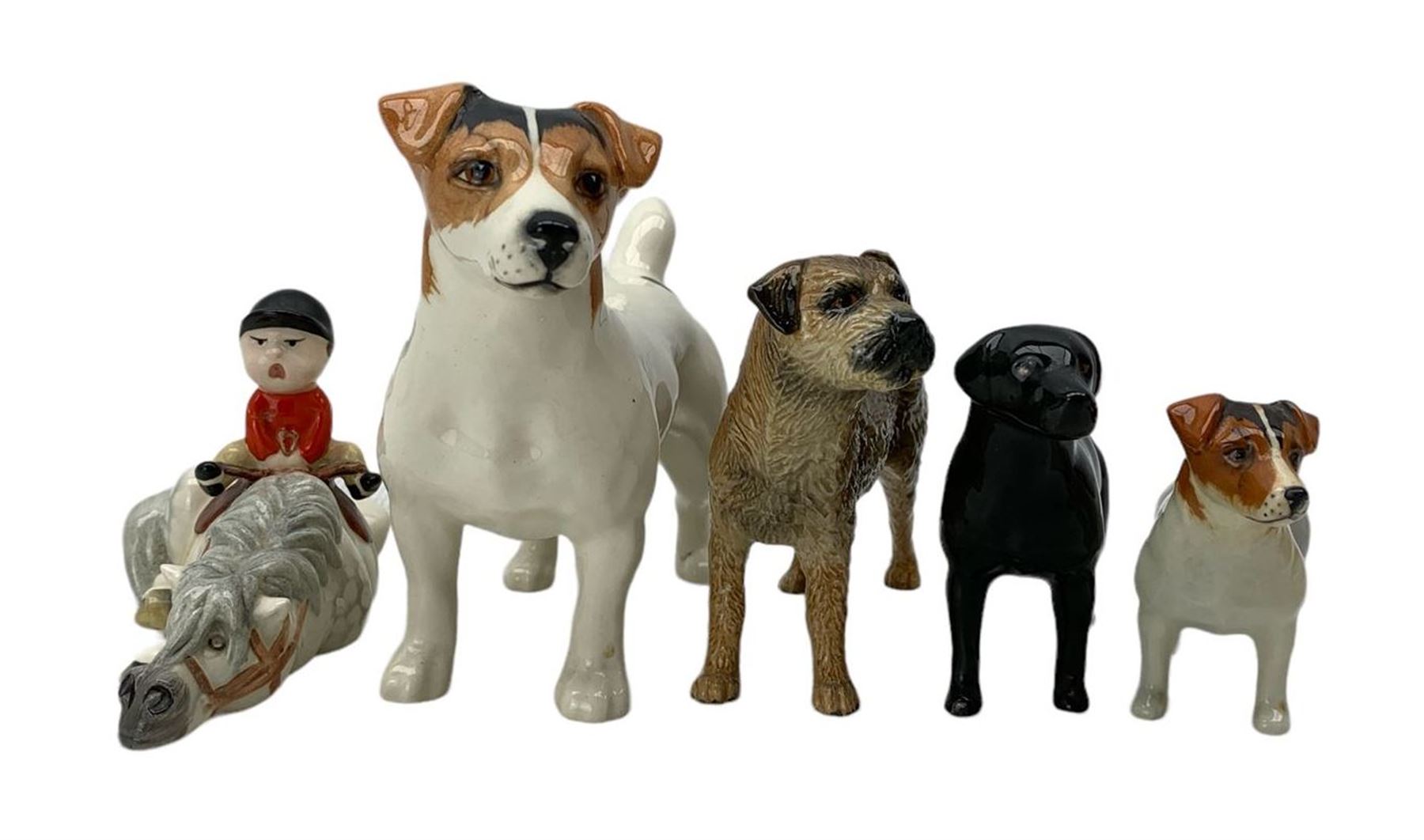 Beswick animals comprising John Beswick Norman Thelwell figure 'Kick-Start', John Beswick model of a Border Terrier, Black Labrador and two Jack Russell Terriers (5)