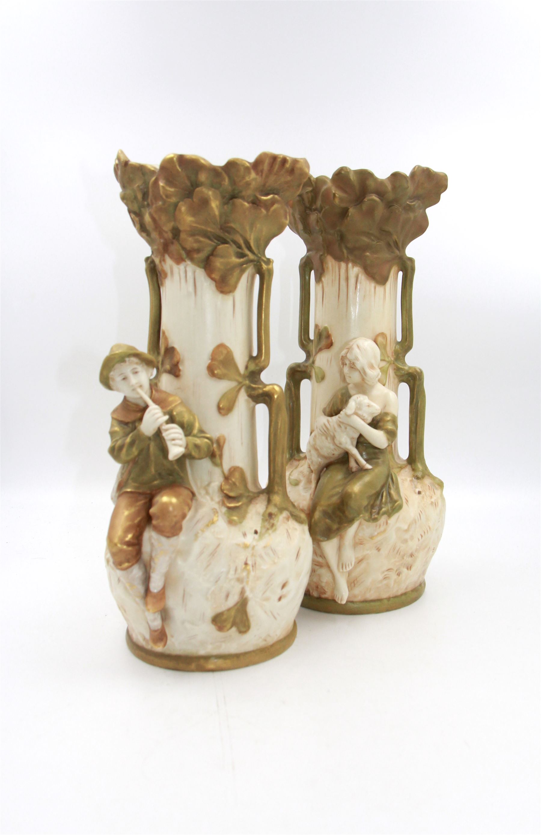 Pair of Royal Dux twin handled vases, no. 1966 & 1967, one depicting a shepherd and the other a shepherdess, each upon a naturalistically textured green, cream and gilt ground, both with pink triangle mark beneath, H31cm