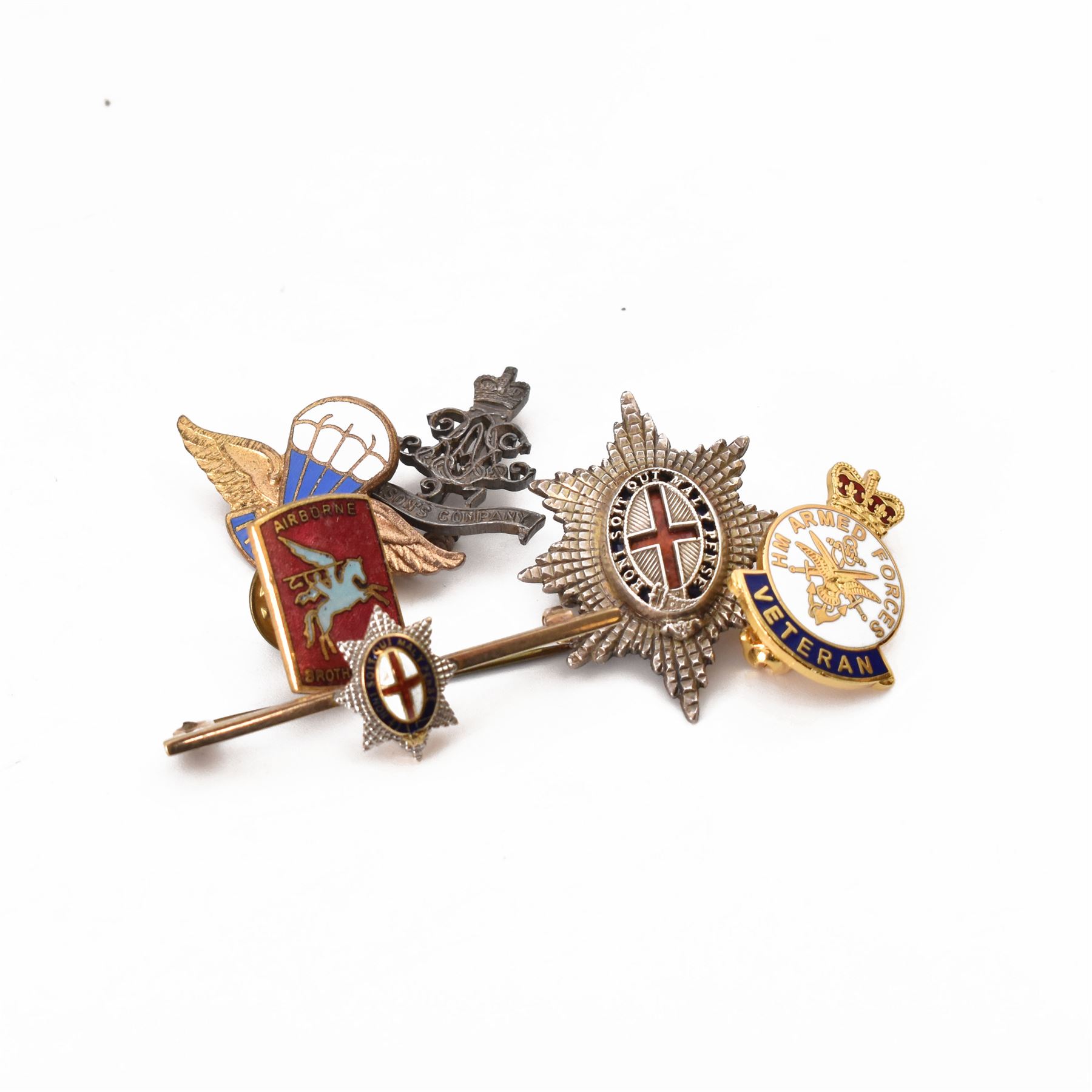 Six badges including 9ct gold and silver order of the garter stars, silver 97th Battery Lawsons Company RA badge etc