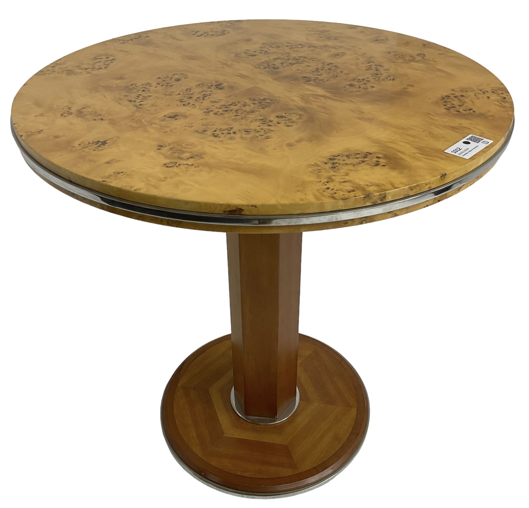 Art Deco design maple and cherry wood pedestal table, circular top with figured quarter matched veneers, mounted by chromed metal band, octagonal pedestal on circular platform base