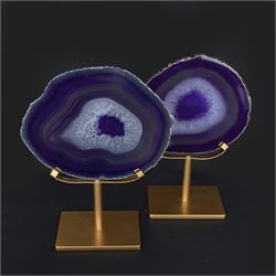 Pair of purple agate slices, polished with rough edges, raised upon gilt metal stands, H22cm