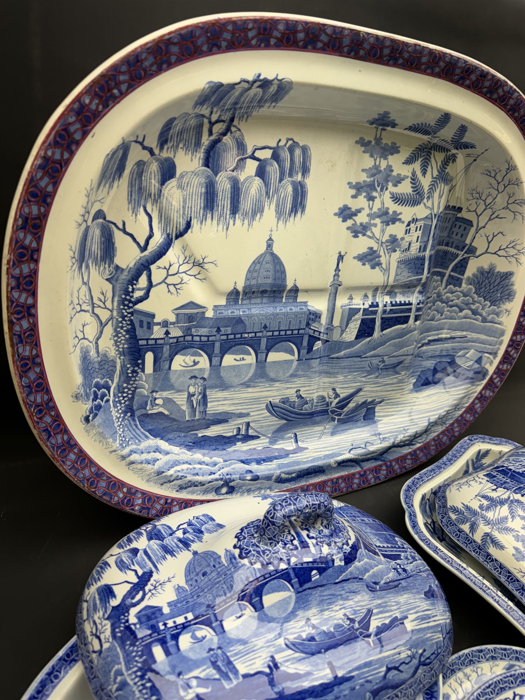 19th century Spode blue and white dinner service for six place settings, decorated in the Tiber pattern, comprising six dinner plates, six dessert plates, meat drainer with red clobbered edge, oval serving dish with twin compartmented interior and matched cover, square serving dish with cover, and two oval platters