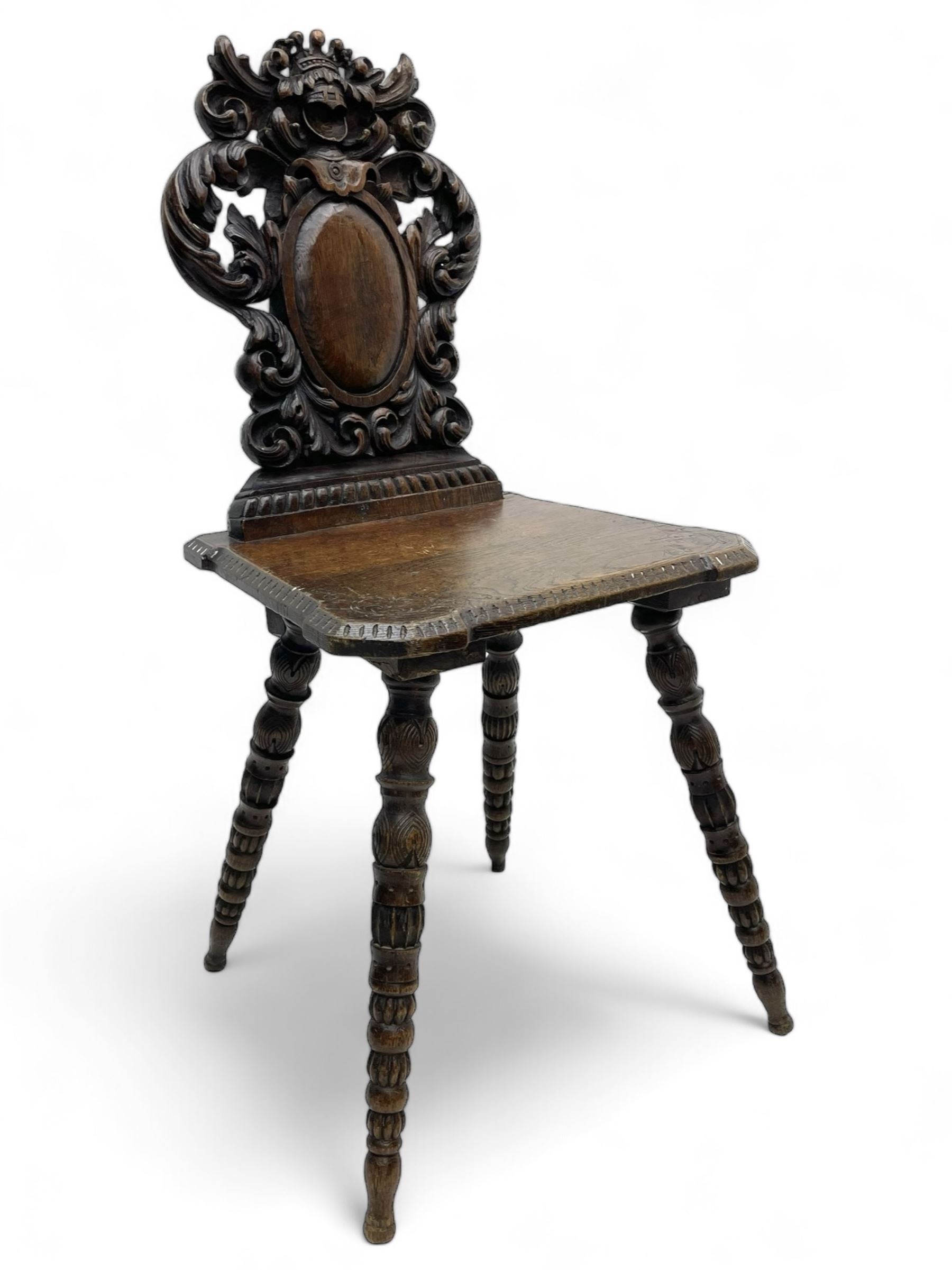 19th century oak hall chair, shaped and pierced back carved with crown cresting over curled and scrolled acanthus leaves, tapered rectangular seat with foliate carved corners and fluted chamfered edge, on turned and lobe carved splayed supports 