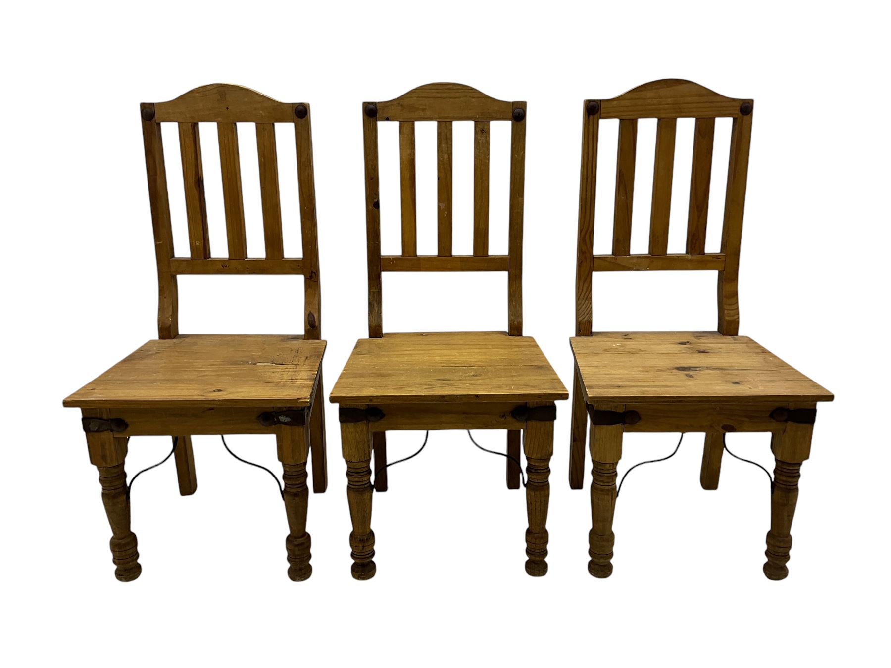 Set of six waxed pine dining chairs, shaped cresting over vertical slat back, plank seat on turned front supports 