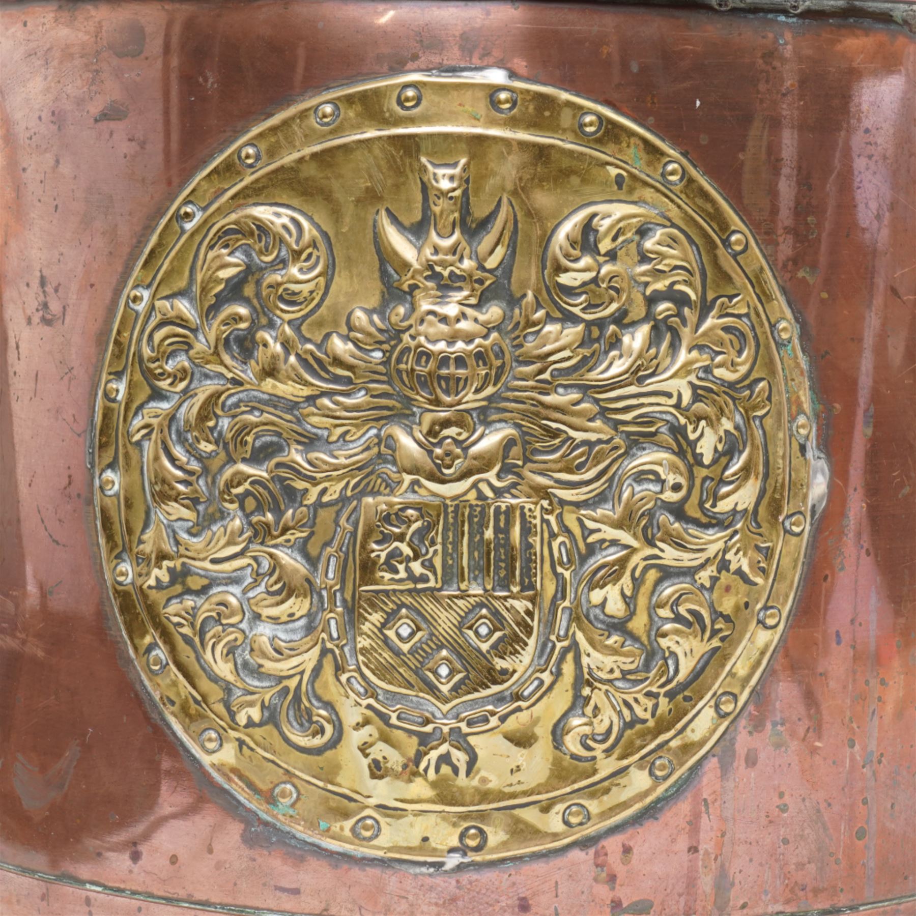 19th century riveted copper and brass mounted coal bucket, the central panel depicting a coat of arms H29cm 