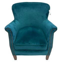 Contemporary tub-shaped armchair, upholstered in teal blue fabric, with high back and rolled arms accented with brass studded trim, on square tapered front feet