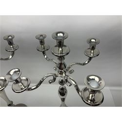 Pair of four branch candelabras, urn-shaped nozzles raised upon scroll branches supported from tapering central stem, with circular base, H70cm