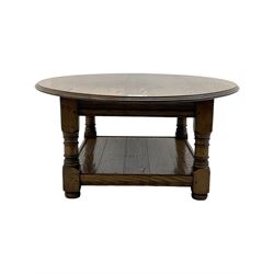 Traditional oak coffee table, moulded oval top, four turned pillar supports united by undertier