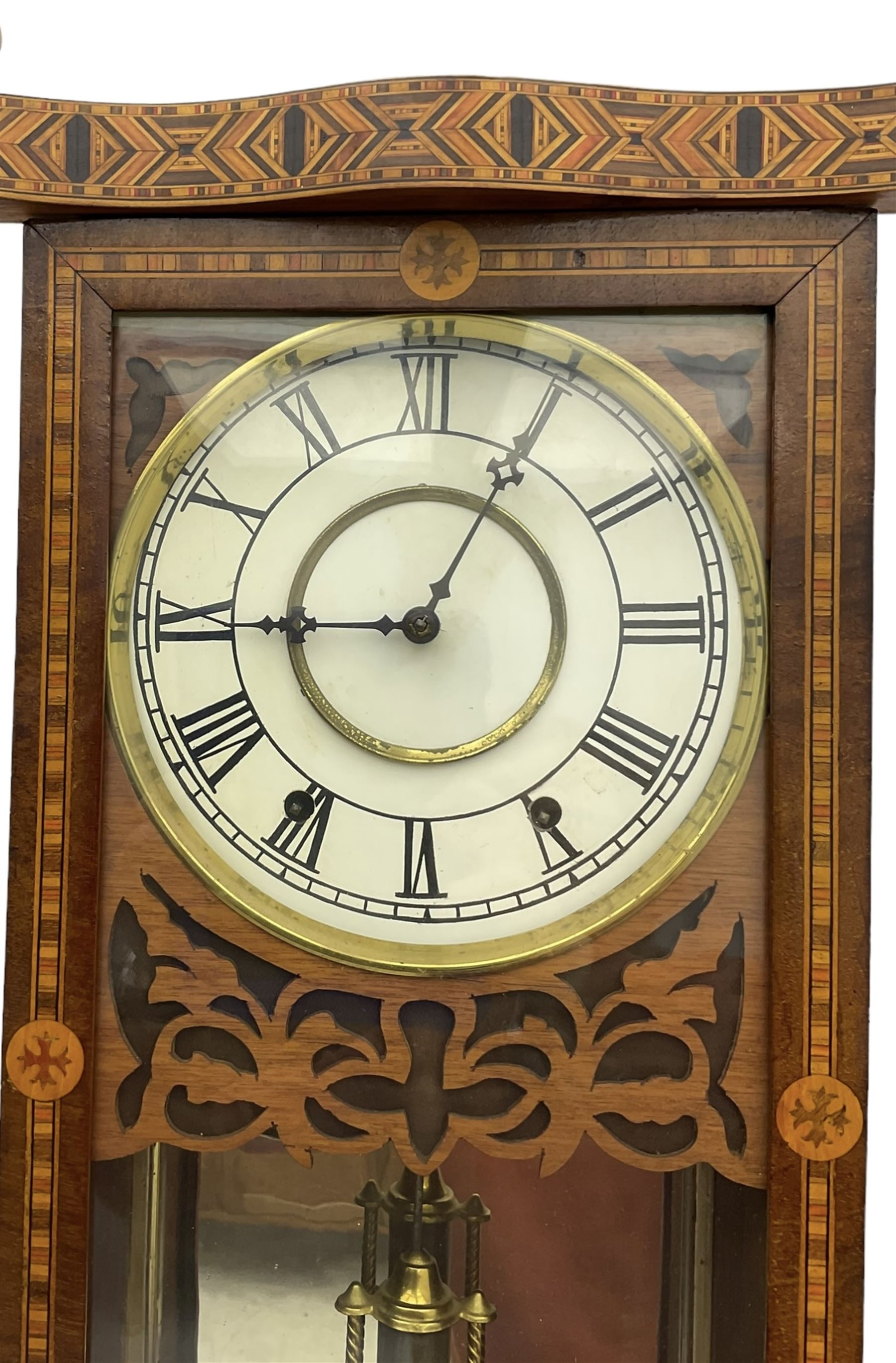 New Haven - American 19th century 8-day wall clock, inlaid parquetry case with fretwork, ring turned pilasters and finials, dial with Roman numerals, minute track and steel hands, with a visible faux mercury pendulum and mirror to the rear of the case, count wheel two train spring driven movement striking the hours on a bell.