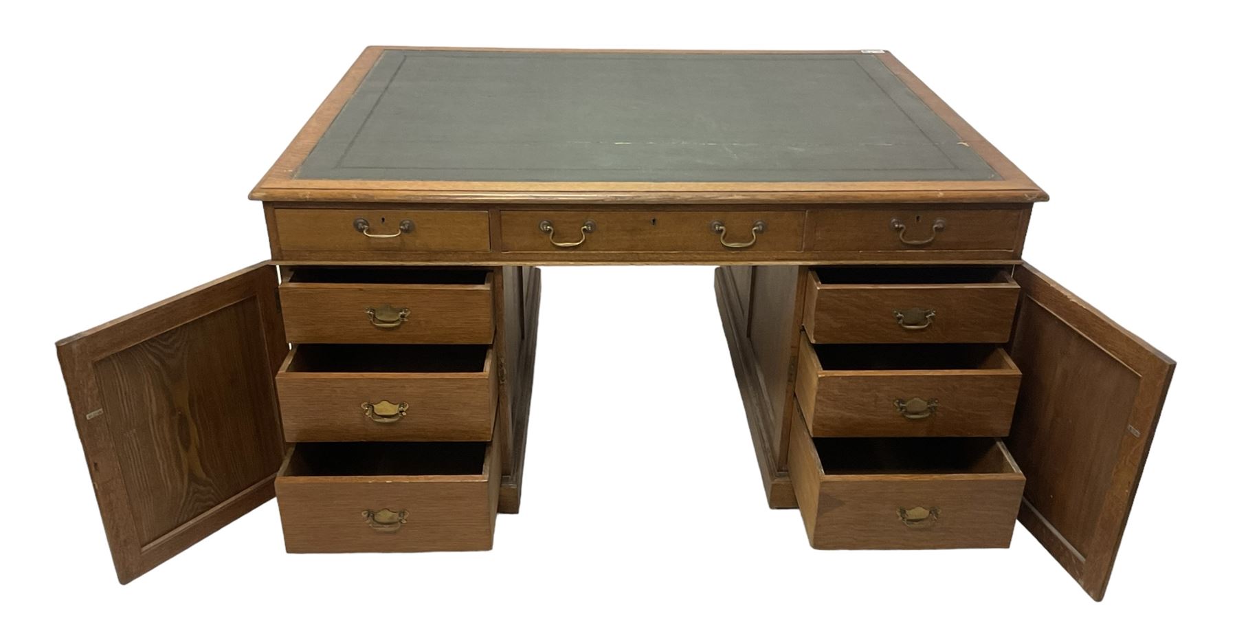 Late 19th century twin pedestal oak partner's desk, rectangular top with inset green leather writing surface, fitted with nine graduating drawers to each side, the rear drawers enclosed by panelled cupboards