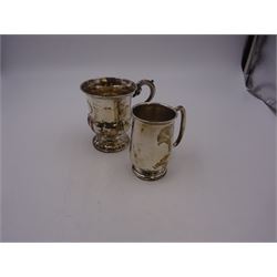 Two silver christening mugs, the first a Victorian example, of part fluted waisted form, upon circular foot with scroll handle, hallmarked Edward, John & William Barnard, London 1838, the second example of plain slightly tapering form with C handle, hallmarked S Blanckensee & Son Ltd, Chester 1929, tallest H9cm