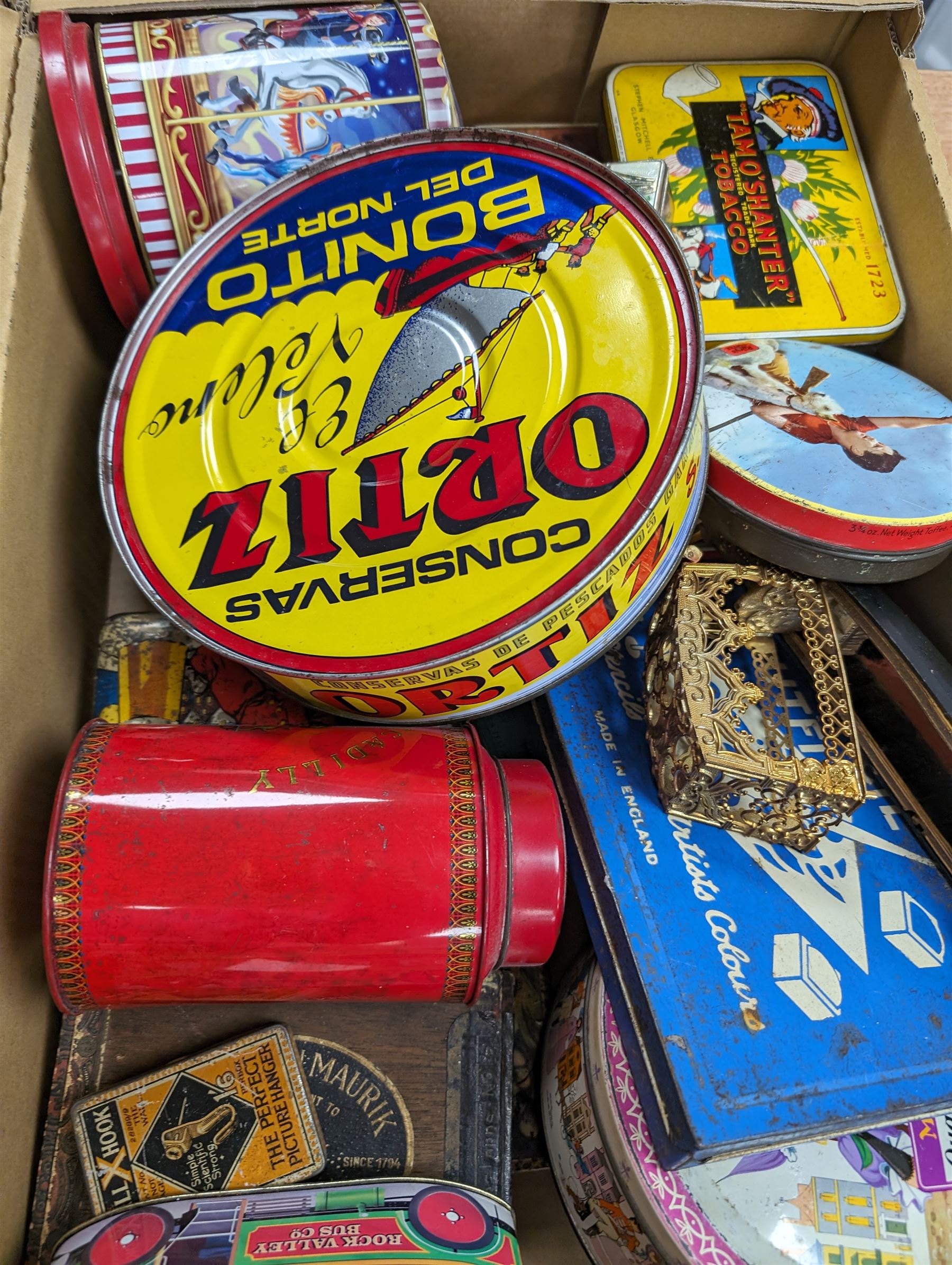 Collection of vintage tins and boxes, including advertising examples