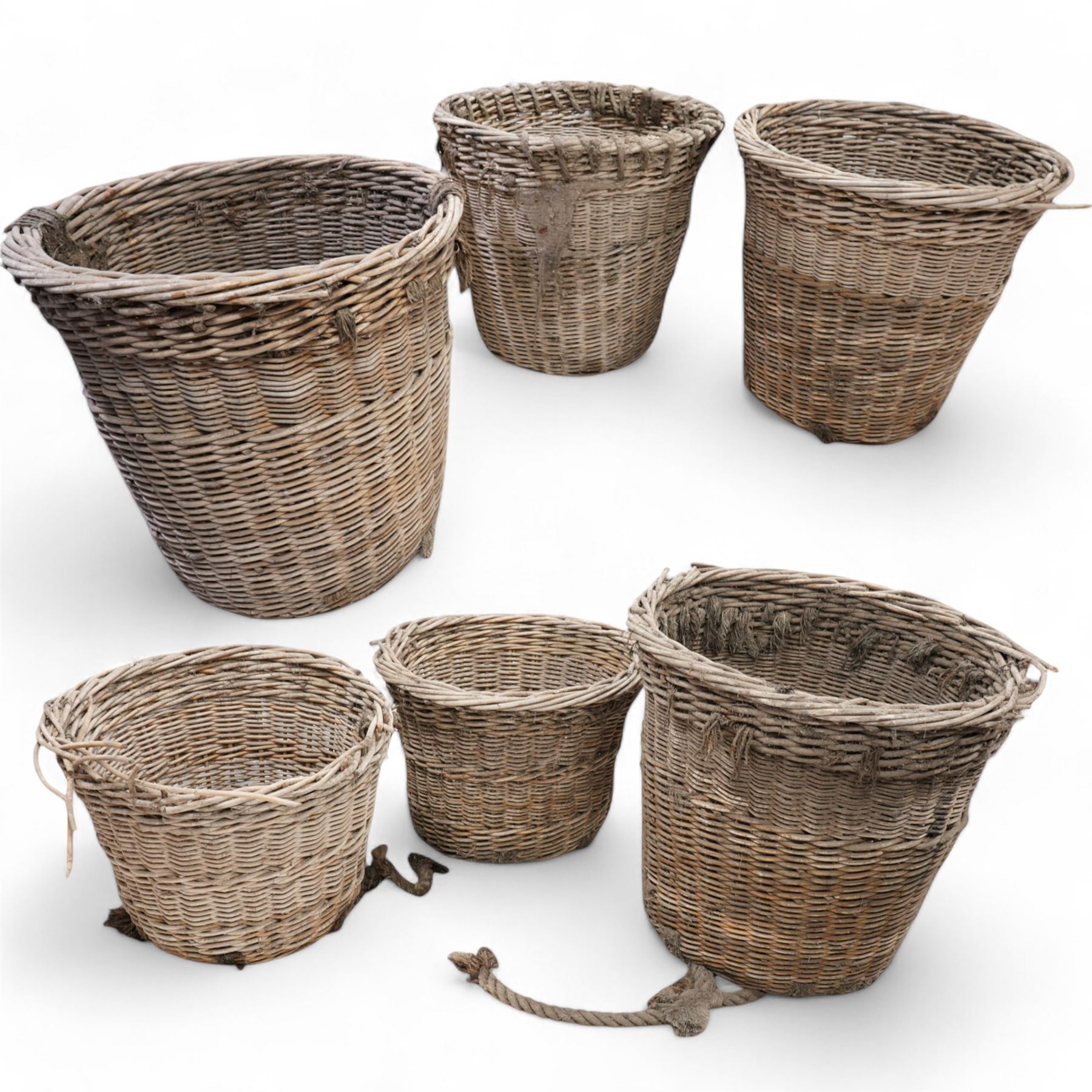 Six large wicker cargo baskets, circular tapering form, the largest height - 81cm