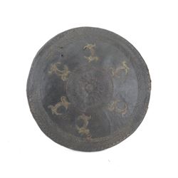  Indian leather dhal shield, of circular from, with applied metal decoration and craved ge...