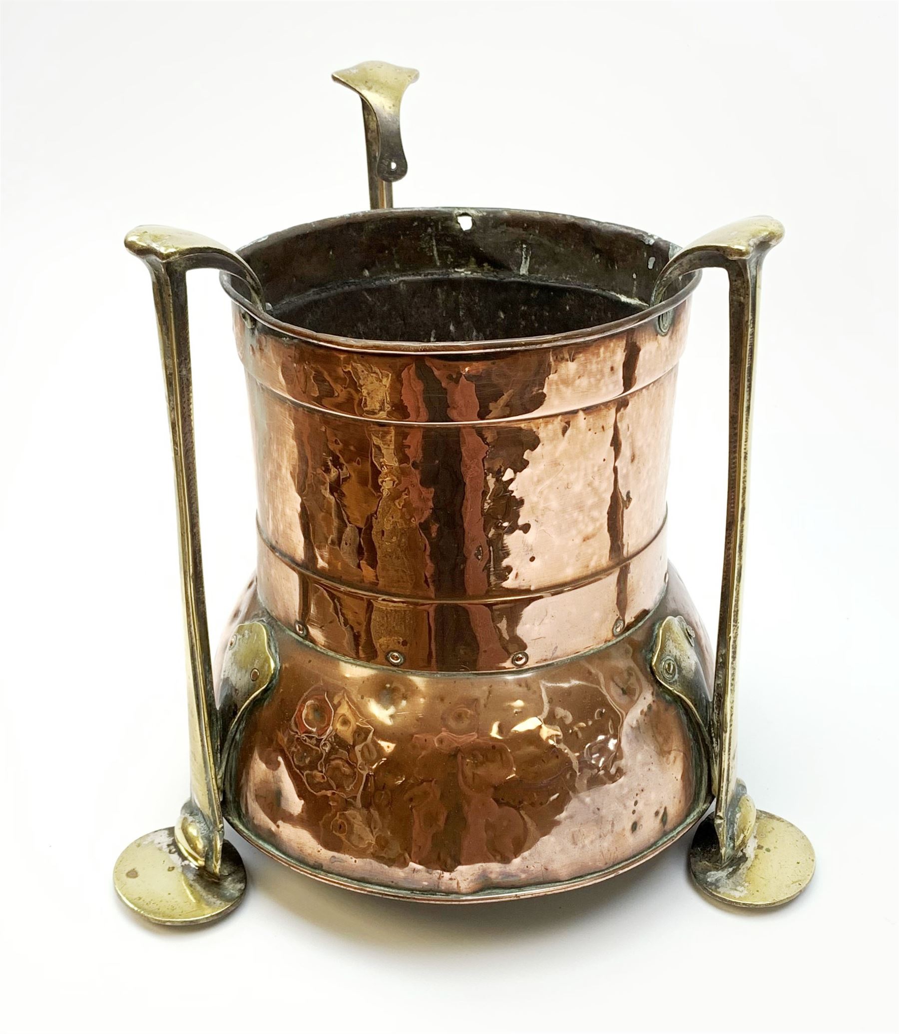 A William Soutter & Sons Arts & Crafts copper jardinière, with three stylised brass supports, with impressed mark beneath, (a/f), H30cm.