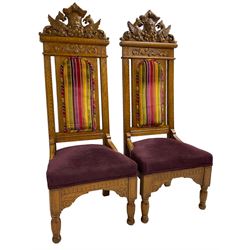 Set of six 20th century Carolean design oak high back chairs, the pediment carved with dragons and central Green Man mask with trailing foliage, the backs upholstered in striped fabric, on turned front supports