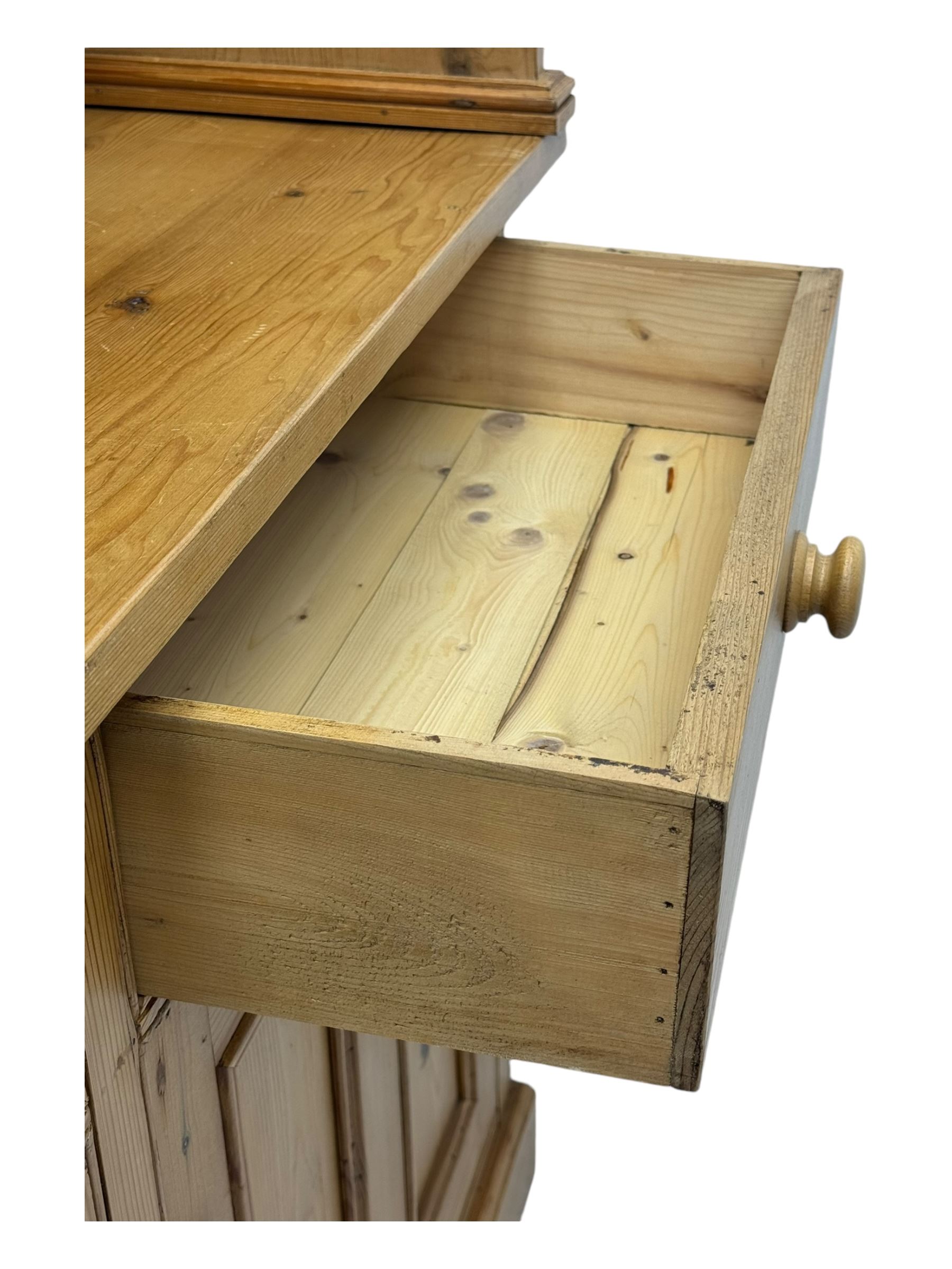 Large pine dresser, raised display cabinets over three drawers and three panelled cupboards, on plinth base