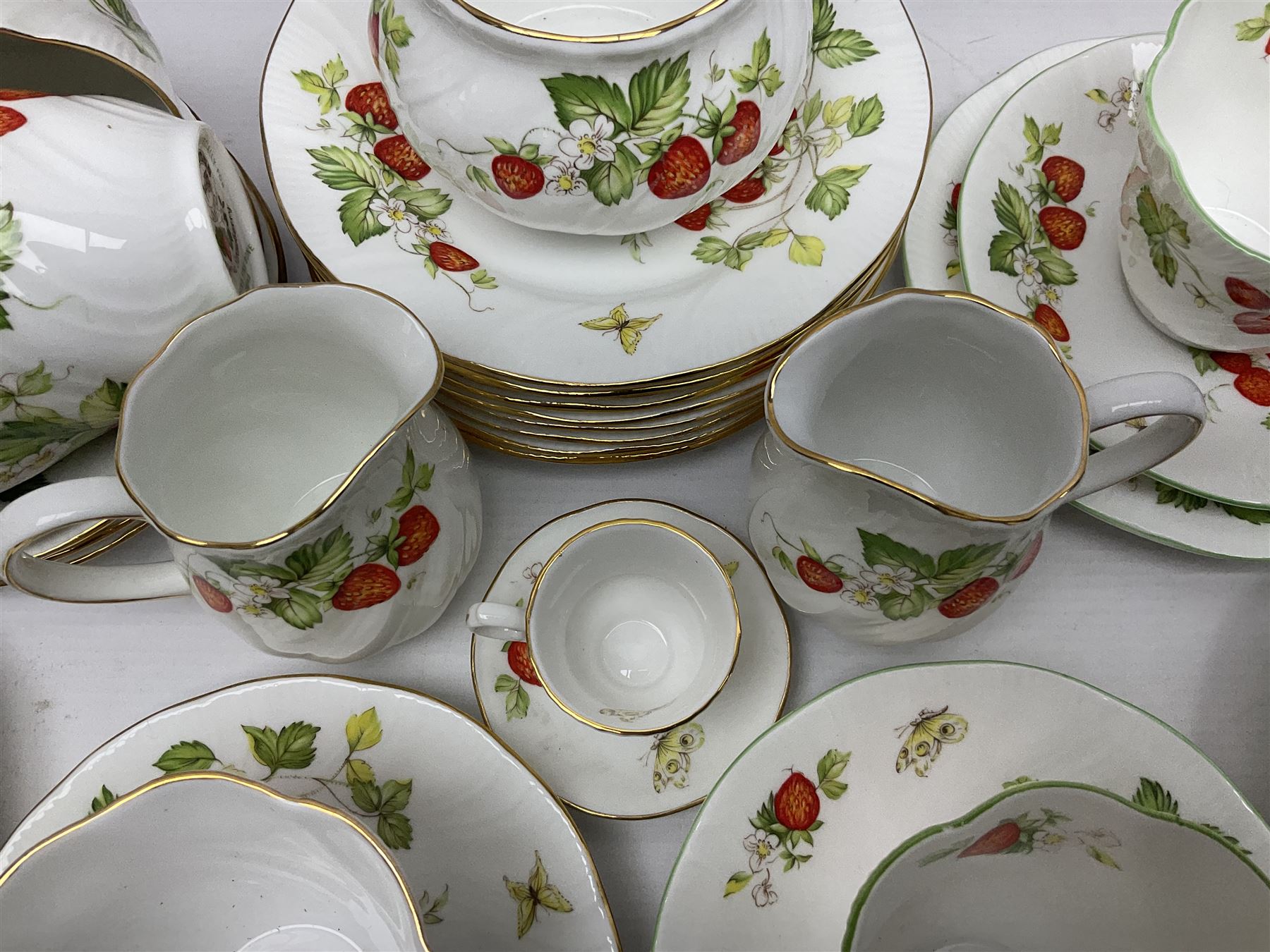 Ringtons and Queen's China Virginia Strawberry pattern teawares, including teacups, saucers, milk jugs, sugar bowls, etc