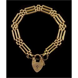 Early 20th century 15ct rose gold three bar gate bracelet, with heart locket clasp, stamped 15