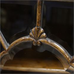 Early 20th century heavily carved oak display cabinet, frieze carved with grape vines over three astragal glazed doors with bevelled glass, over three cupboards applied with octagonal carved panels with further vine carvings, on turned and lobe carved supports