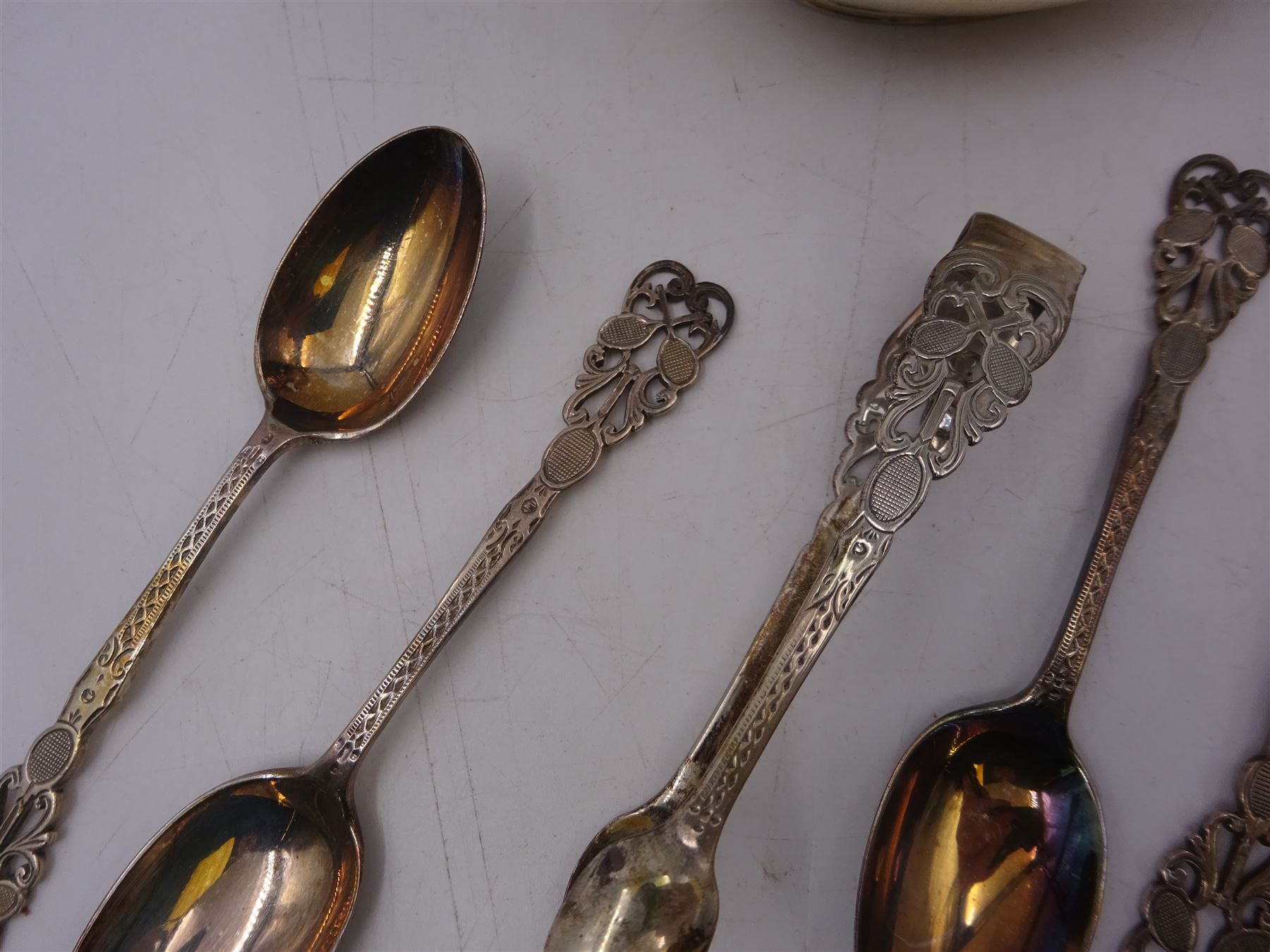 Early 20th century silver jug, of oval slightly bellied form, with angular handle and banded decoration to body, hallmarked Fordham & Faulkner, Sheffield 1911, together with set of five 1920s silver tennis themed coffee spoons and sugar tongs, hallmarked  Josiah Williams & Co (David Landsborough Fullerton), London 1922, jug H9cm