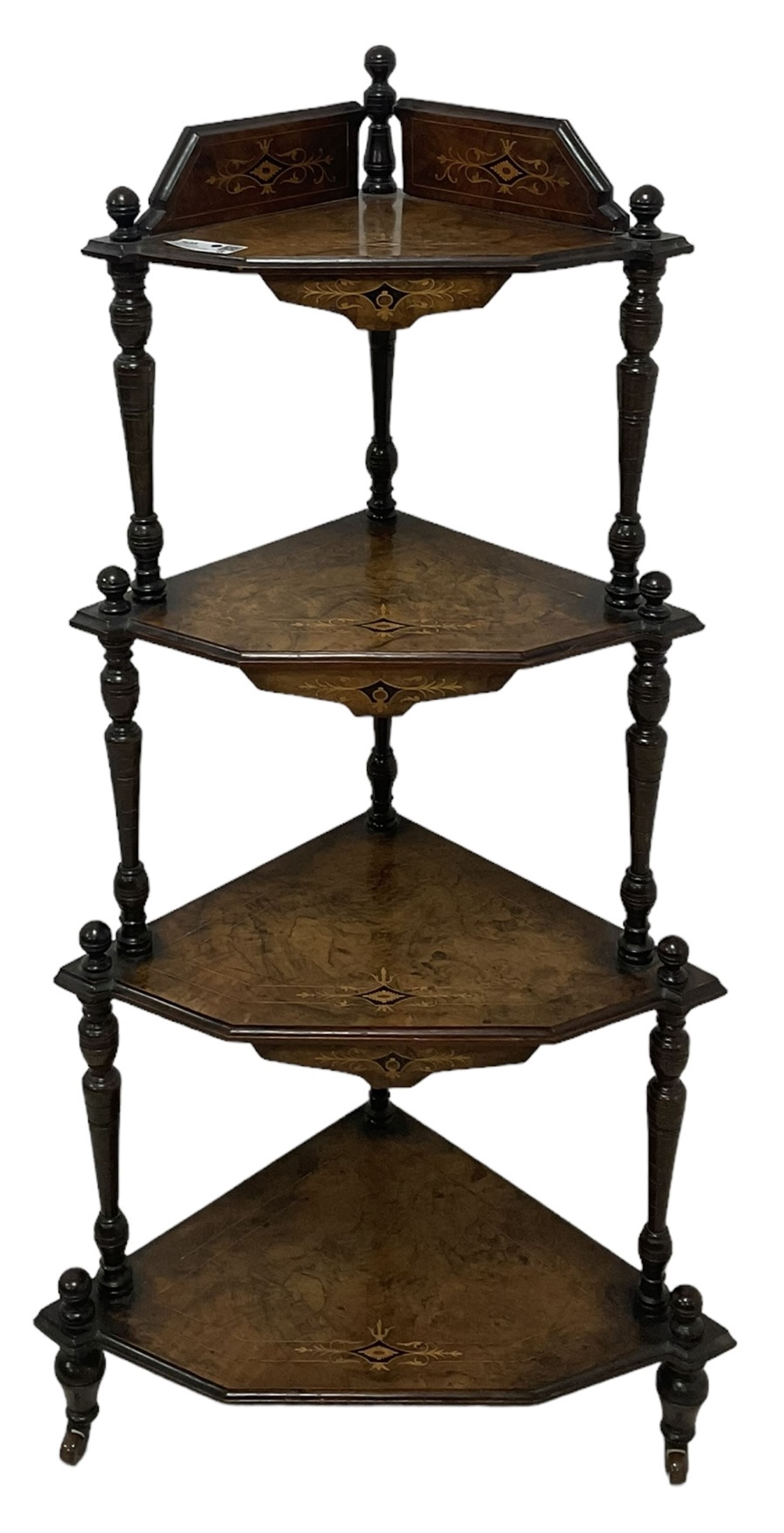 Victorian inlaid walnut corner four-tier whatnot, raised back over four graduating tiers of triangular form, decorated with satinwood and ebony inlays, united by tapering ring turned uprights, on castors