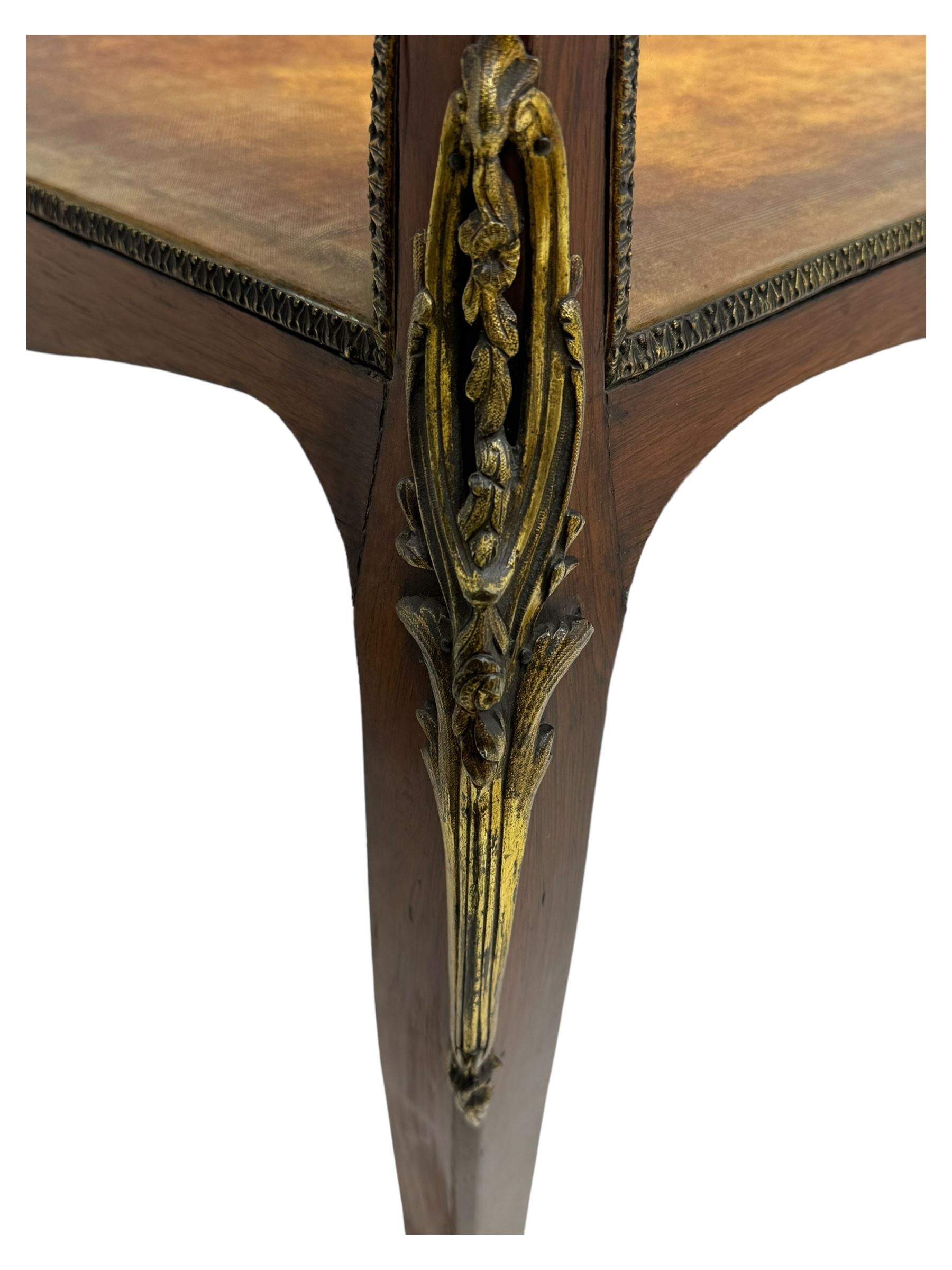 Victorian inlaid rosewood bijouterie table cabinet, shaped form, enclosed by hinged bevel glazed lid with shell and floral inlays, fabric lined interior, glazed sides within foliate cast gilt metal edging, on cabriole supports with floral cast gilt metal mounts and terminal caps 