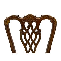 Set of twelve Chippendale design mahogany dining chairs, shaped cresting rail carved with foliage and C-scrolls, pierced interlaced splat with curled leaf decoration, upholstered drop-in seat, moulded seat rails, on scrolled acanthus carved cabriole supports with ball and claw feet 