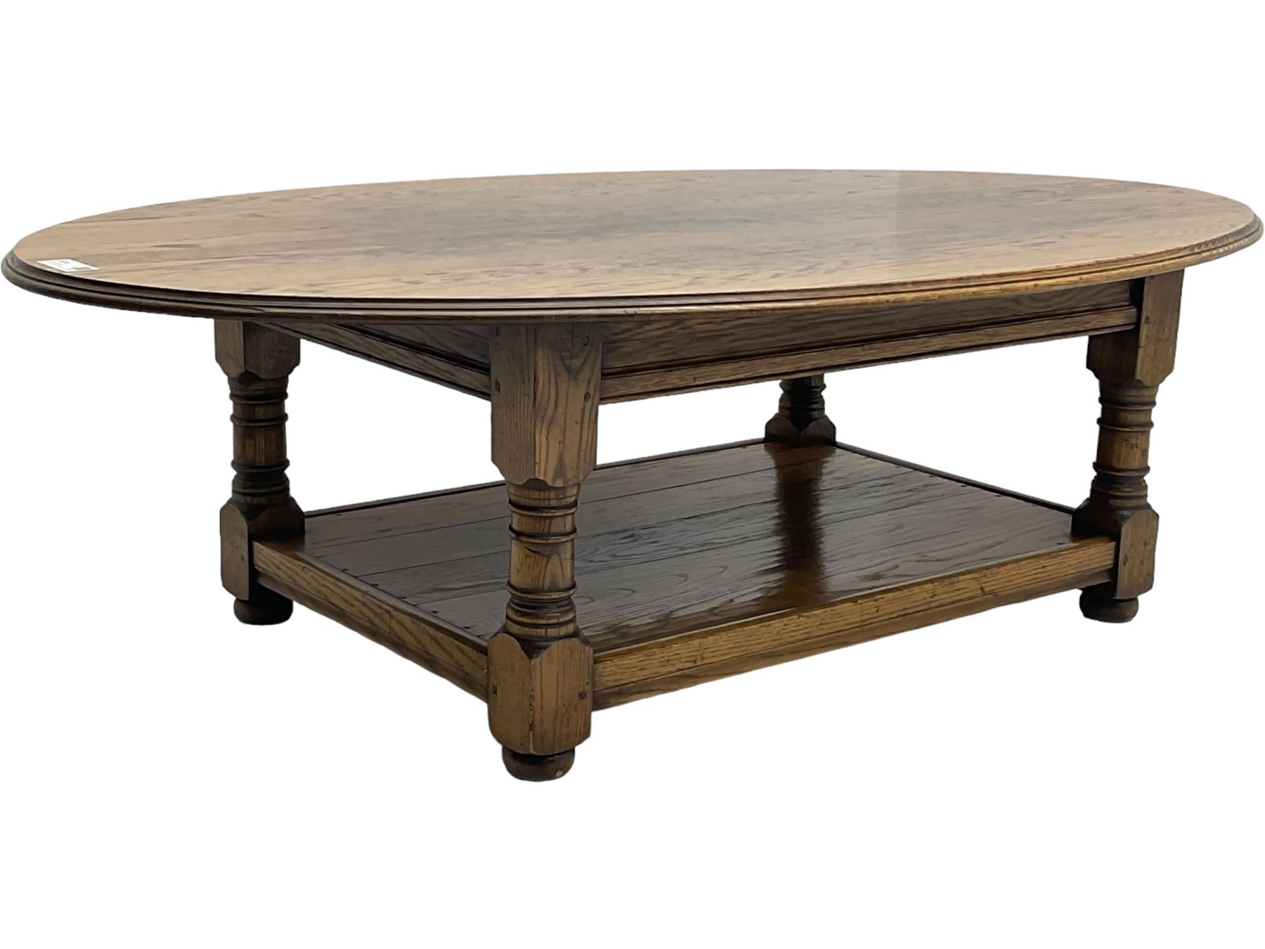 Traditional oak coffee table, moulded oval top, four turned pillar supports united by undertier