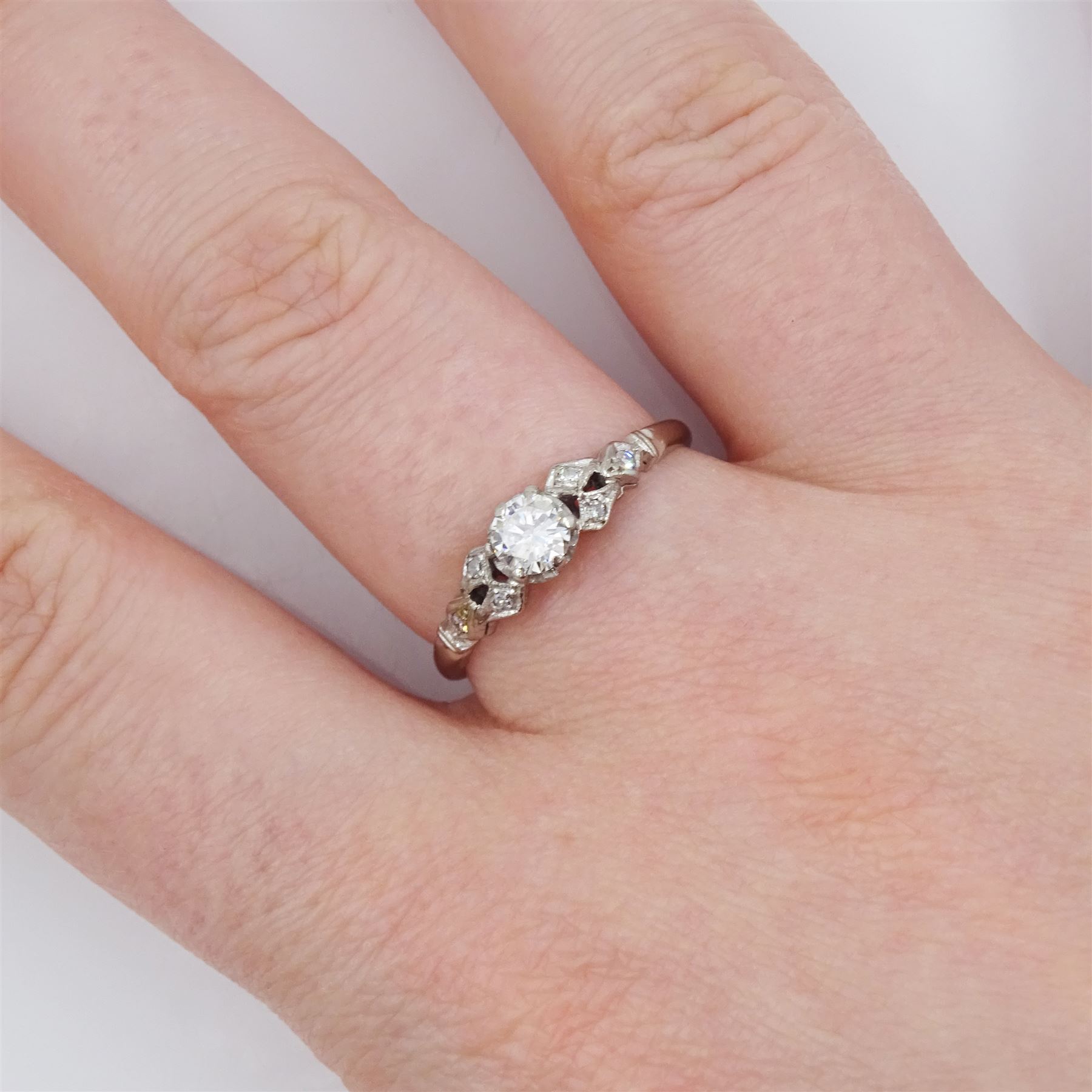 White gold single stone round brilliant cut diamond ring, with milgrain set diamond openwork shoulders, stamped 18ct, principal diamond approx 0.25 carat