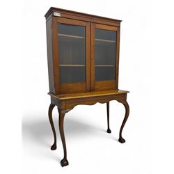 Late 19th century oak display cabinet, rectangular form with a pair of glazed doors enclos...