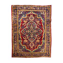 Mid-20th century Persian ground rug, featuring a bold red field and large lobed medallion,...