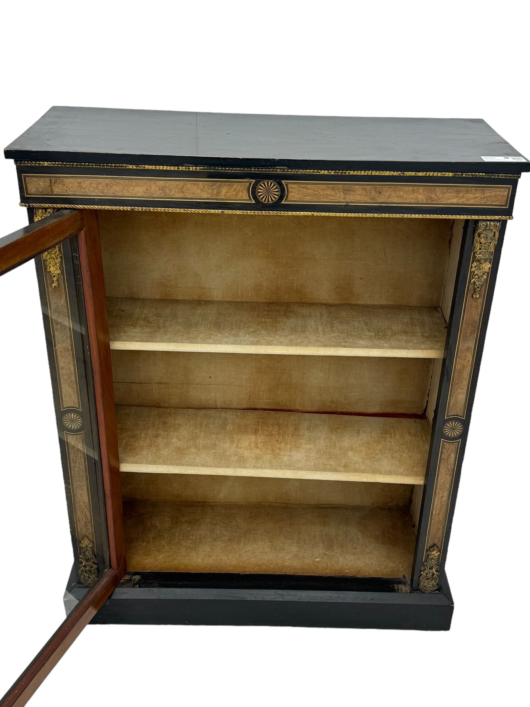 Victorian ebonised and walnut pier cabinet, rectangular top over figured frieze with central star motifs, enclosed by single glazed door, decorated with cast gilt metal mounts and beading, on chamfered plinth base 