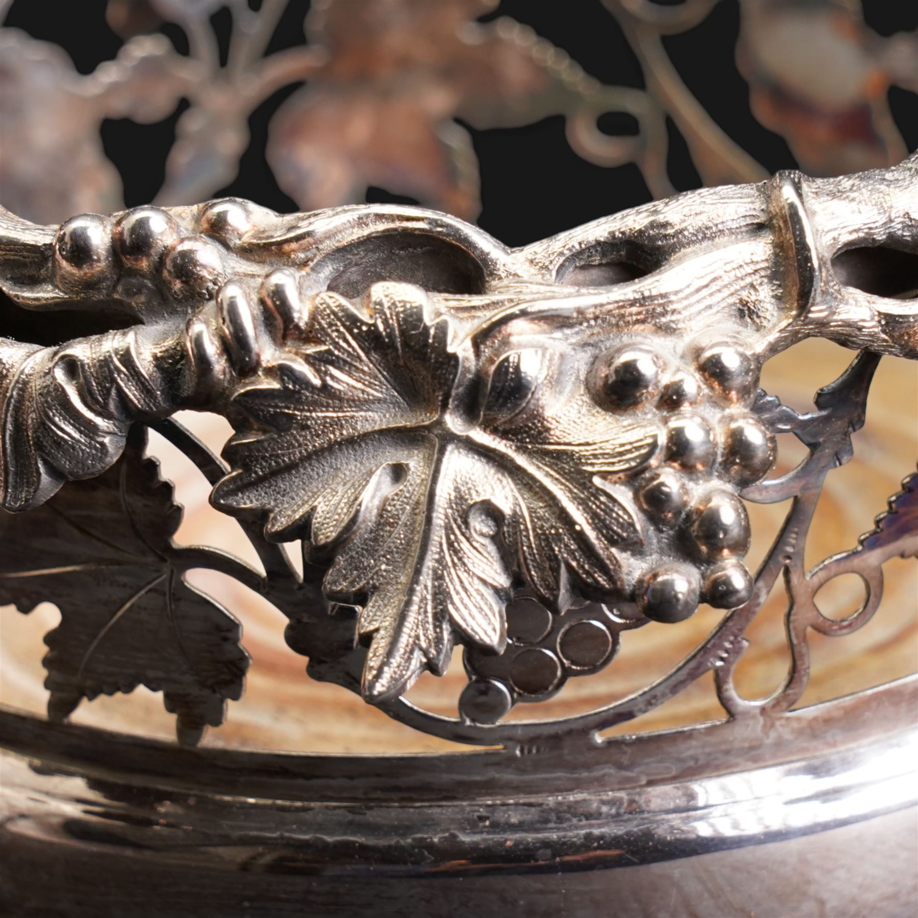 20th century silver-plated bottle coaster with grape vine decoration, cut glass claret jug with silver-plated mounts, H30cm and an early 20th century Elkington silver plate soup tureen, lacking cover 