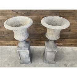 Pair of large Georgian design cast stone garden urns, egg and dart border, tapering column on square base, raised on square column