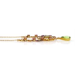 Early 20th century 15ct gold peridot, pink tourmaline and seed pearl necklace, two pear cut peridot drops, suspending from circular floral deign pendant, set with round cut tourmalines and seed pearls, to three further floral clusters and two tourmalines set either side, on trace link chain necklace, stamped 15c