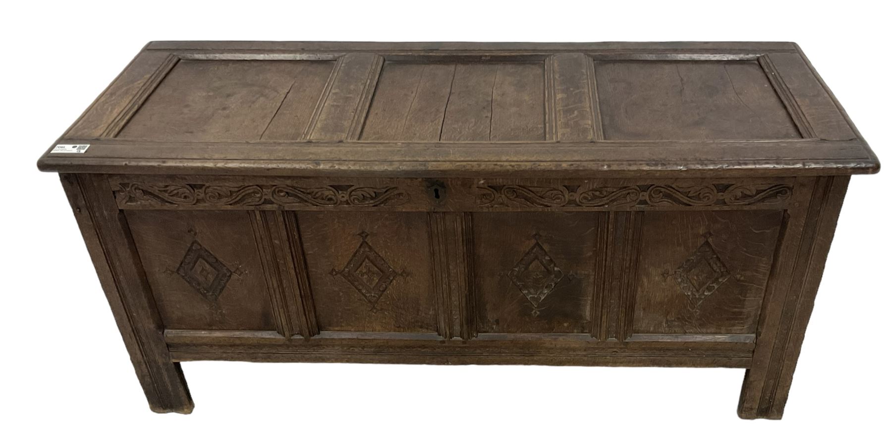 18th century oak coffer or chest, rectangular hinged panelled top with moulded frame enclosing candle box, the frieze carved with foliate S-scrolls over a quadruple panel front decorated with carved lozenges, on stile supports