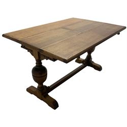 Early 20th century oak 'Ee-zi-Way one motion extending dining table', rectangular top over twin baluster end supports united by stretcher