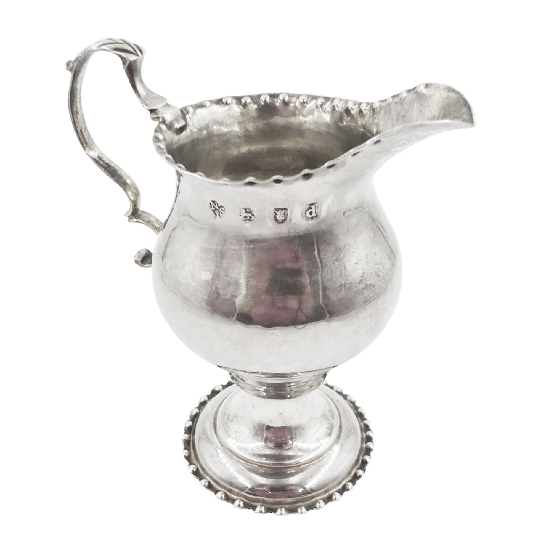 George III silver pedestal cream jug, with acanthus capped scroll handle, the body with lightly hammered and stipple decoration, upon circular foot, hallmarked Ann Smith & Nathaniel Appleton, London 1779, H11cm