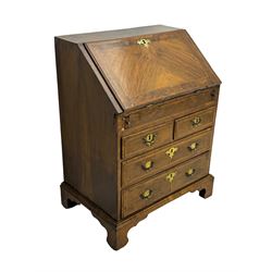 18th century walnut bureau, fall-front enclosing fitted interior with drawers and pigeonholes, over two short and two long drawers with brass escutcheon plates and handles, raised on bracket feet