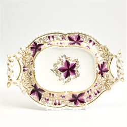 Pair of early 19th century porcelain sauce tureens and covers on stands, possibly Coalport, painted with bands of purple and gilt fruiting vines, within gadroon borders, the stands with naturalistic oak leaf and entwined moulded  handles, the covers with flower knop handles, stand L24cm, overall H18cm