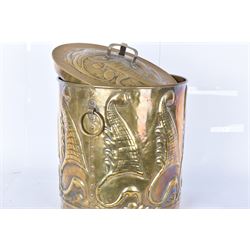 Arts and Craft brass coal box of cylindrical, with embossed stylised leaf panels, with twin handles, the cover with triform handle, H42cm 