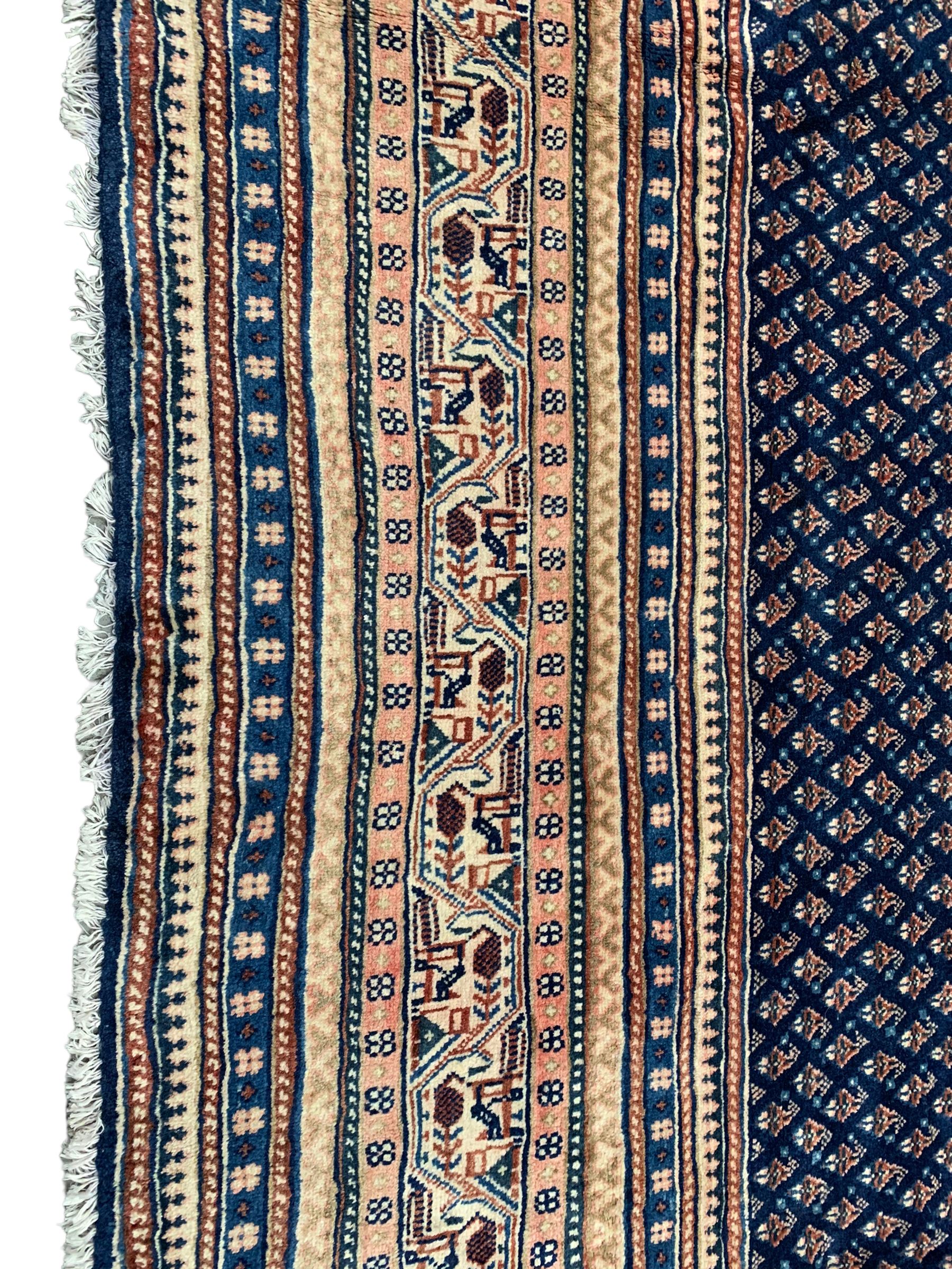 Persian Araak indigo ground carpet, the field decorated with small repeating Boteh motifs, multiple band border decorated with geometric design 