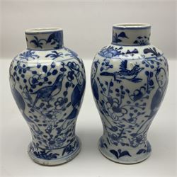 Pair of Chinese blue and white vases, of squat baluster form, each depicting figures holding a ginger jar, with four character Kangxi mark beneath, H13.5cm