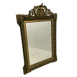 Victorian giltwood and gesso wall mirror, pierced shell cartouche pediment decorated with C-scrolls and curled leaves, moulded frame with curled acanthus leaf decoration and beaded inner slip, the corner brackets decorated with flower heads 