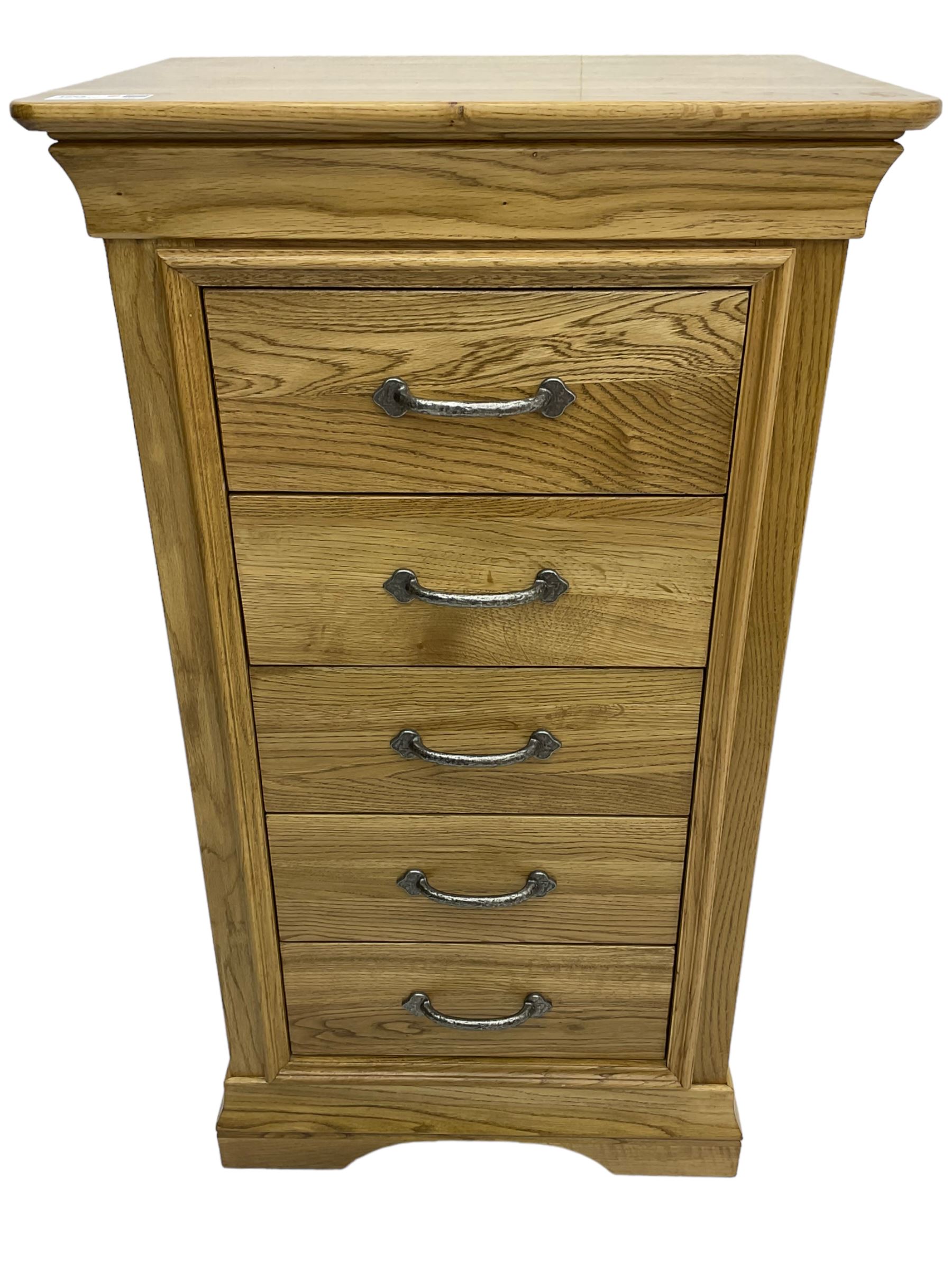 Contemporary light oak pedestal chest, moulded cornice and chamfered rectangular top with rounded fronts, over five drawers with metal handles and cock-beaded surrounds, on bracketed plinth base